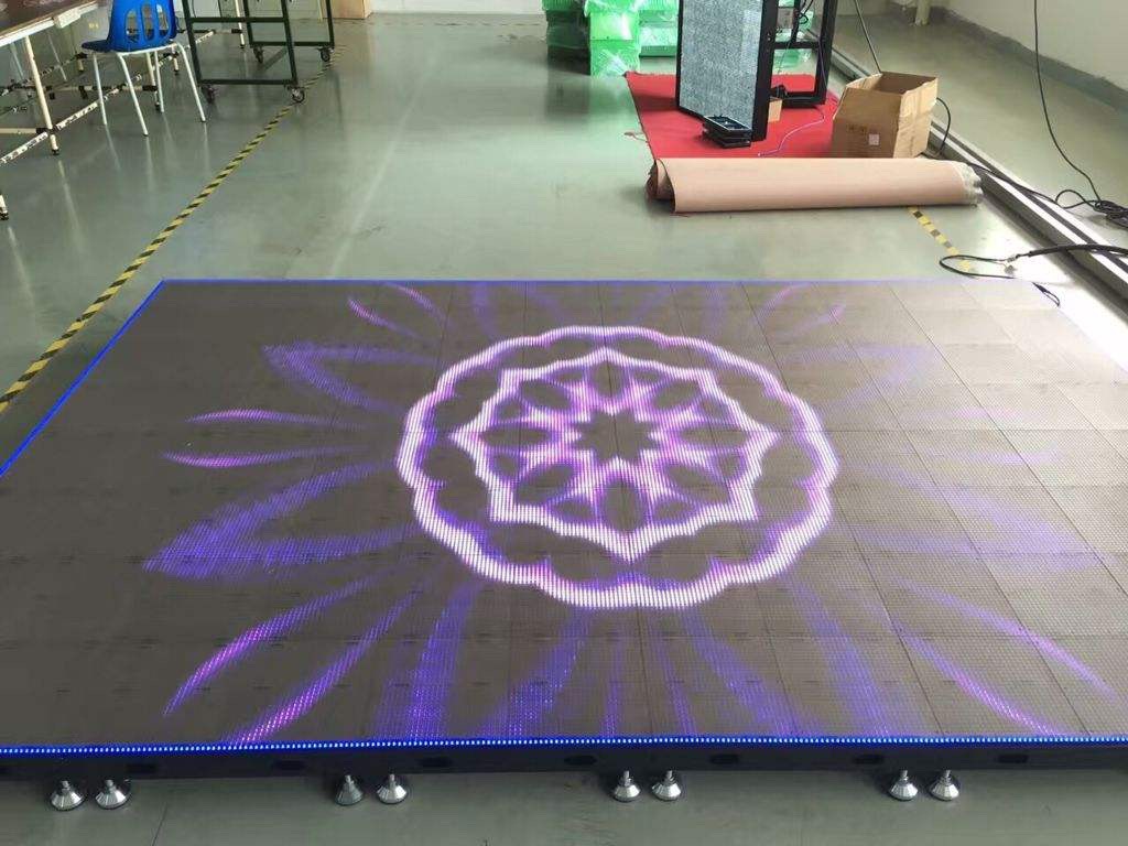Led tile screen in the middle of the ground paved a road