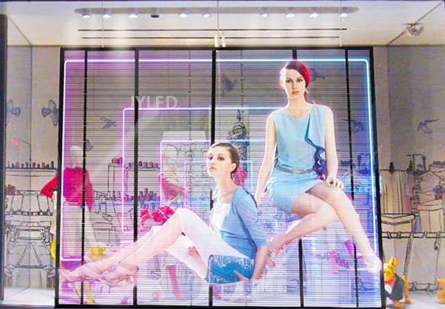 Transparent LED walls display images of clothing models on the glass of clothing stores