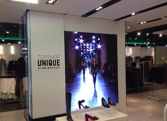 An Indoor LED Display Mounted On The Wall Of A Clothing Store