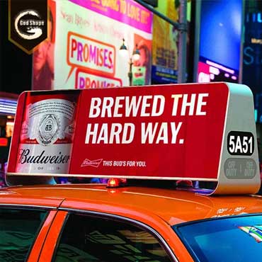 An LED Display On The Roof Of A Taxi Shows A Budweiser Beer Advertisement