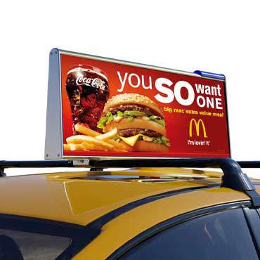An LED Display On The Roof Of A Taxi Shows An Advertisement For McDonald's